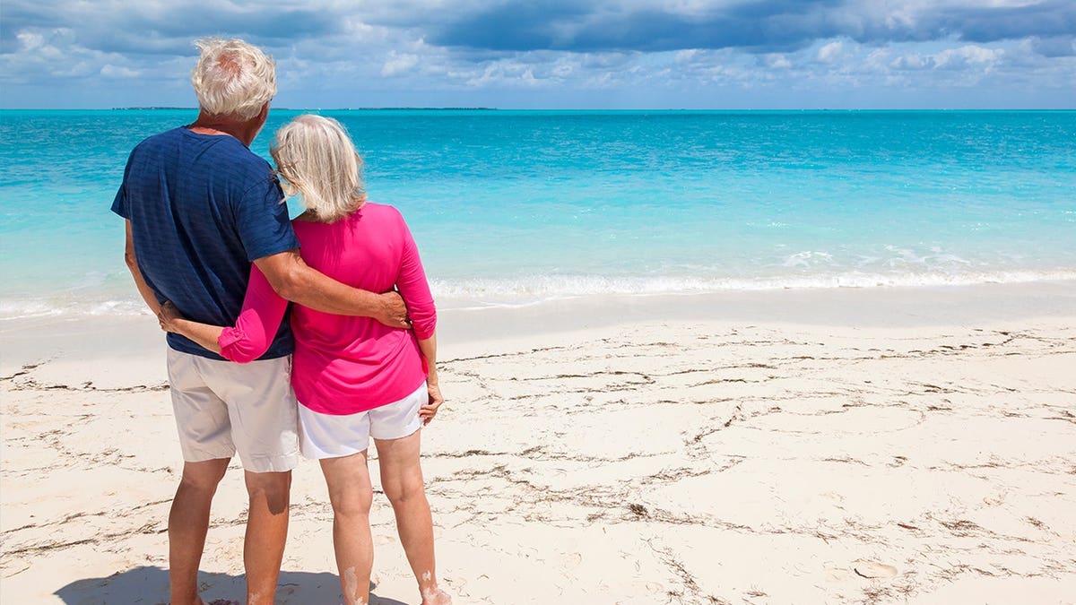 Mature Caucasian senior couple in colourful clothes in the Bahamas