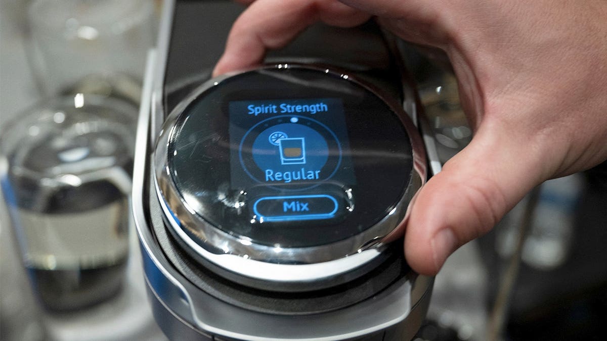 Person adjusts strength of cocktail made with Bartesian