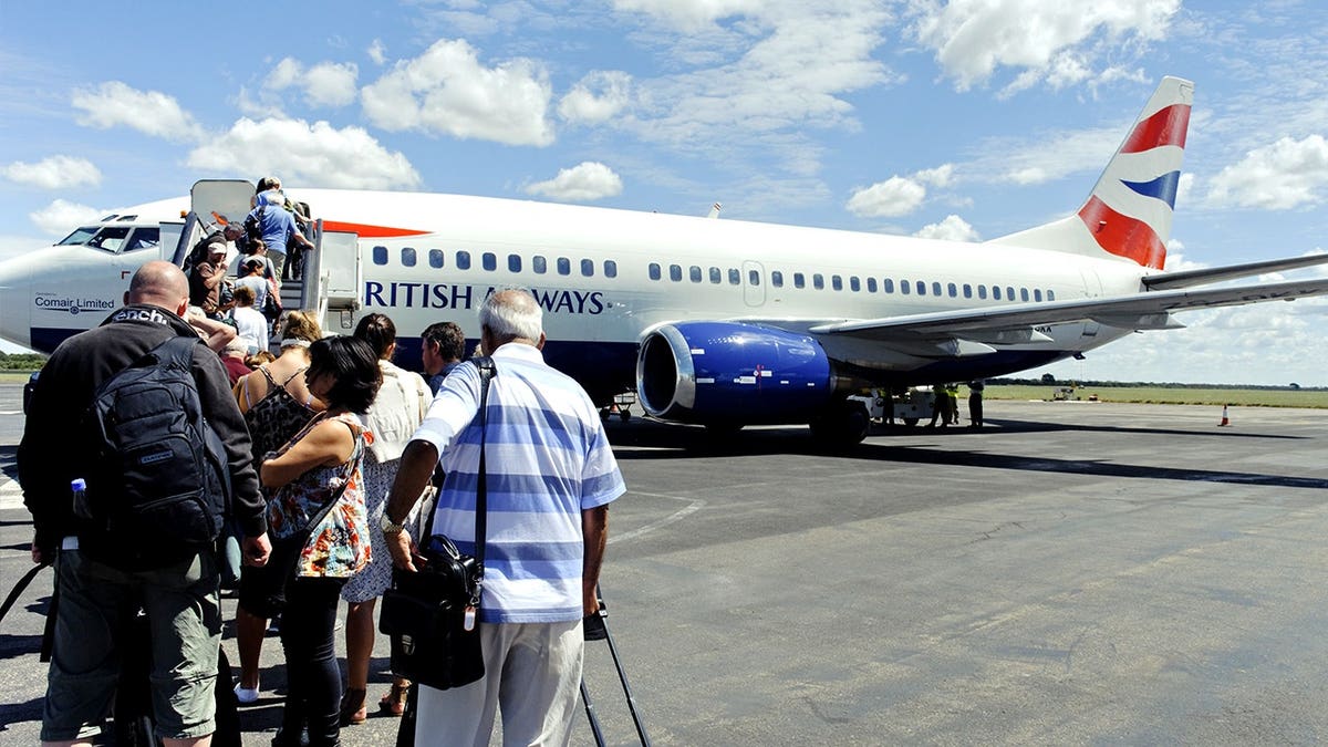 Passengers on runway boarding BA flight