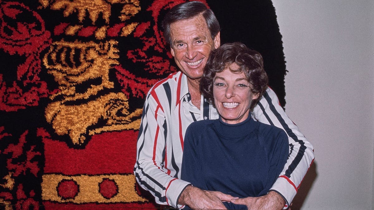 Bob Barker and his wife Dorothy pose before a wall-mounted rug in their Los Angeles home.