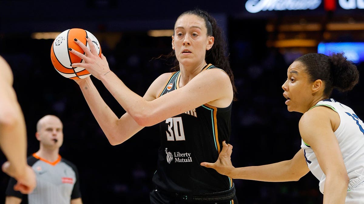 Breanna Stewart looks for a pass as Nia Coffey defends her at Target Center.