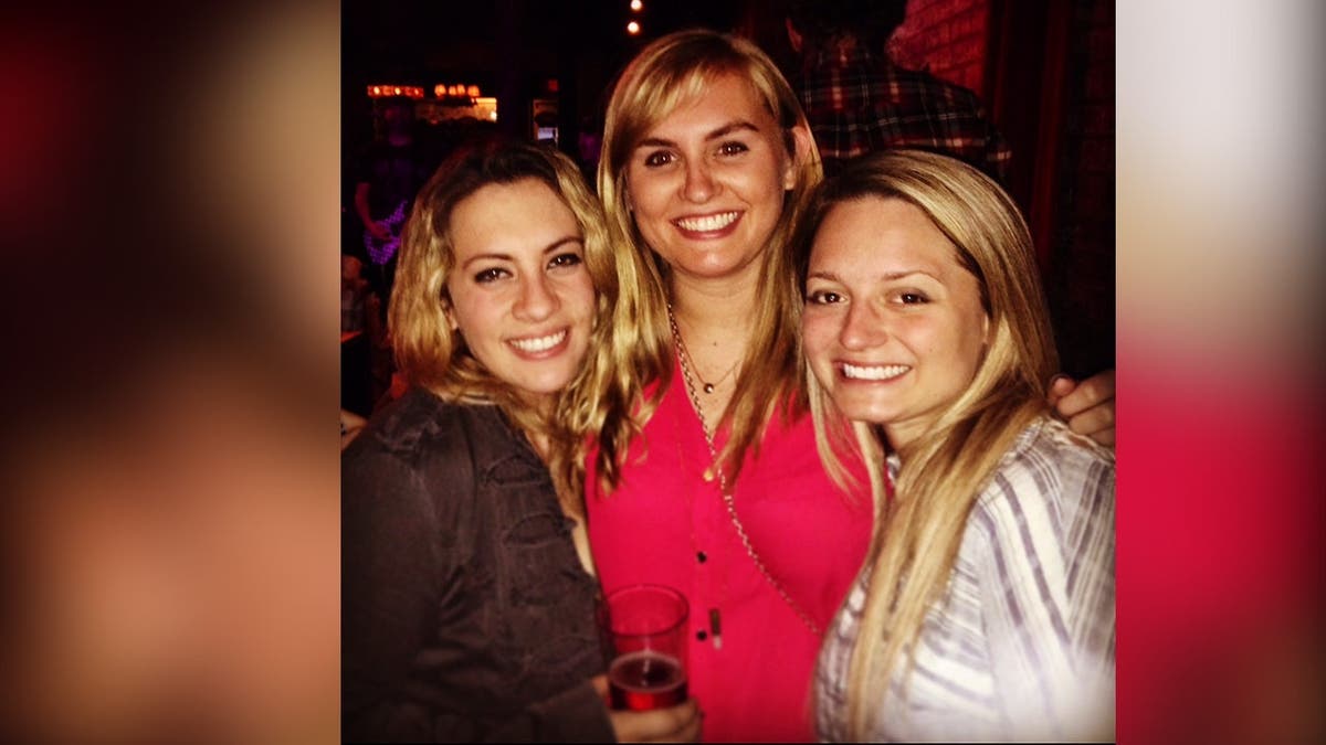 image shows three friends standing for photo