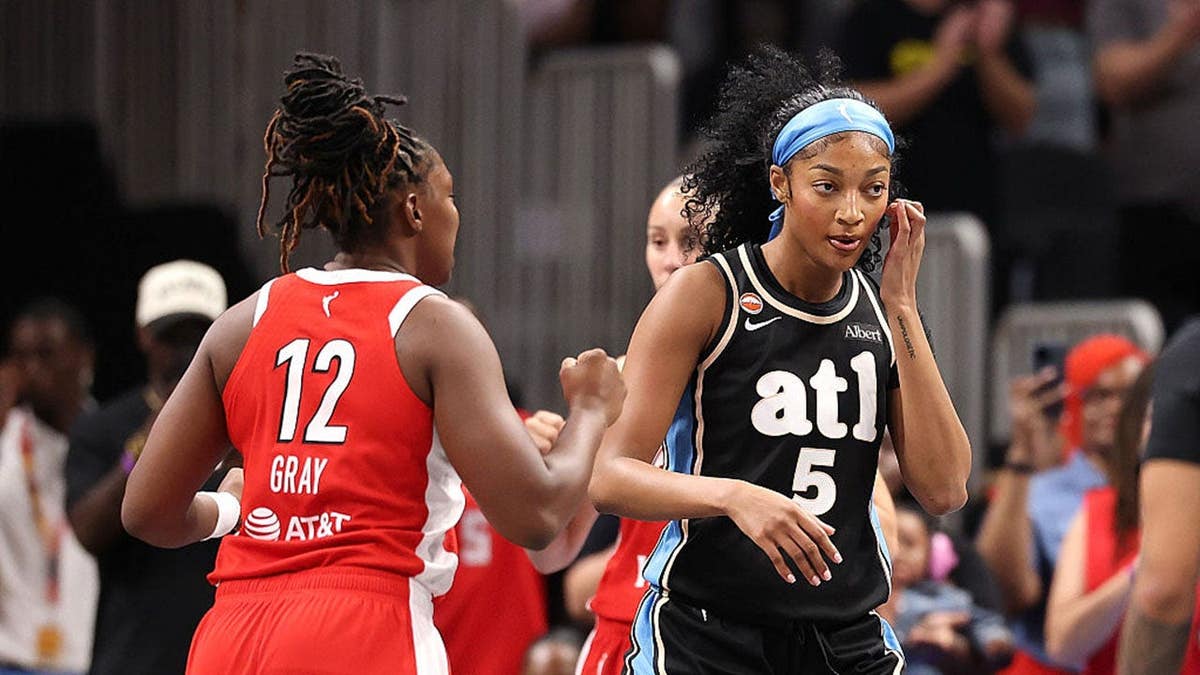 Angel Reese reacts against Chelsea Gray during a game in Atlanta.
