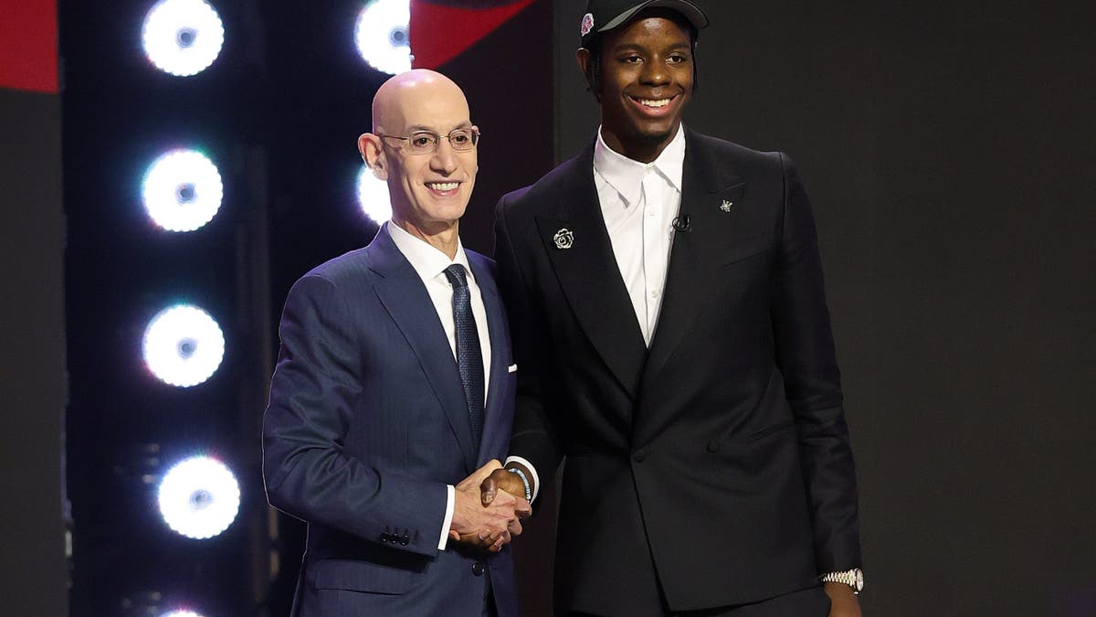 Adam Silver shakes hands with Caleb Wilson at the NBA Draft in New York City.