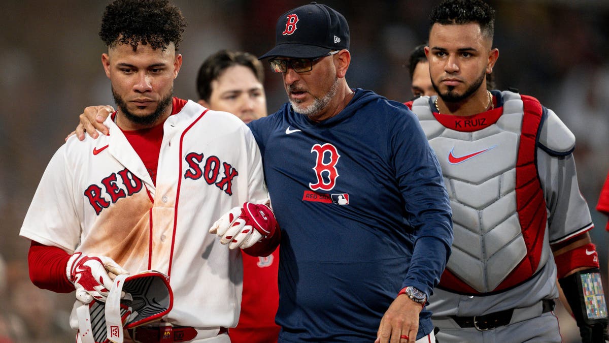 Willson Contreras #40 reacts with Interim Bench Coach José David Flores #58 after ejection at Fenway Park.