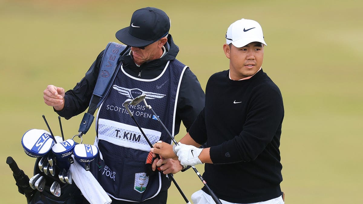 Tom Kim talks with his caddie on the 11th hole at The Renaissance Club.