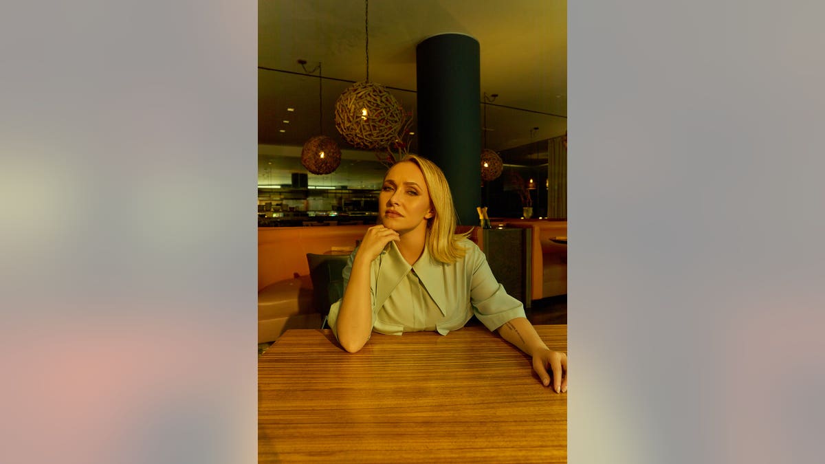 Hayden Panettiere posing indoors to promote her memoir.