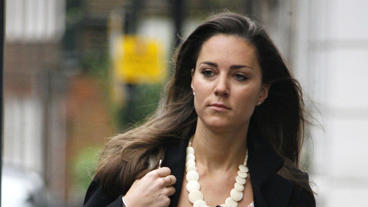 Kate Middleton stands at an event.