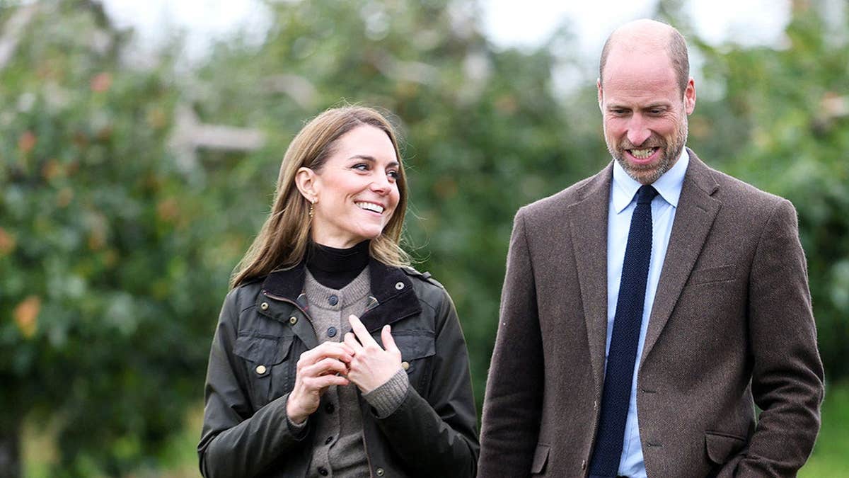 Kate Middleton staring adoringly at Prince William out on a field.