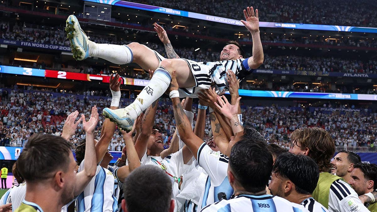 Lionel Messi and Argentina football team players celebrate after a victory