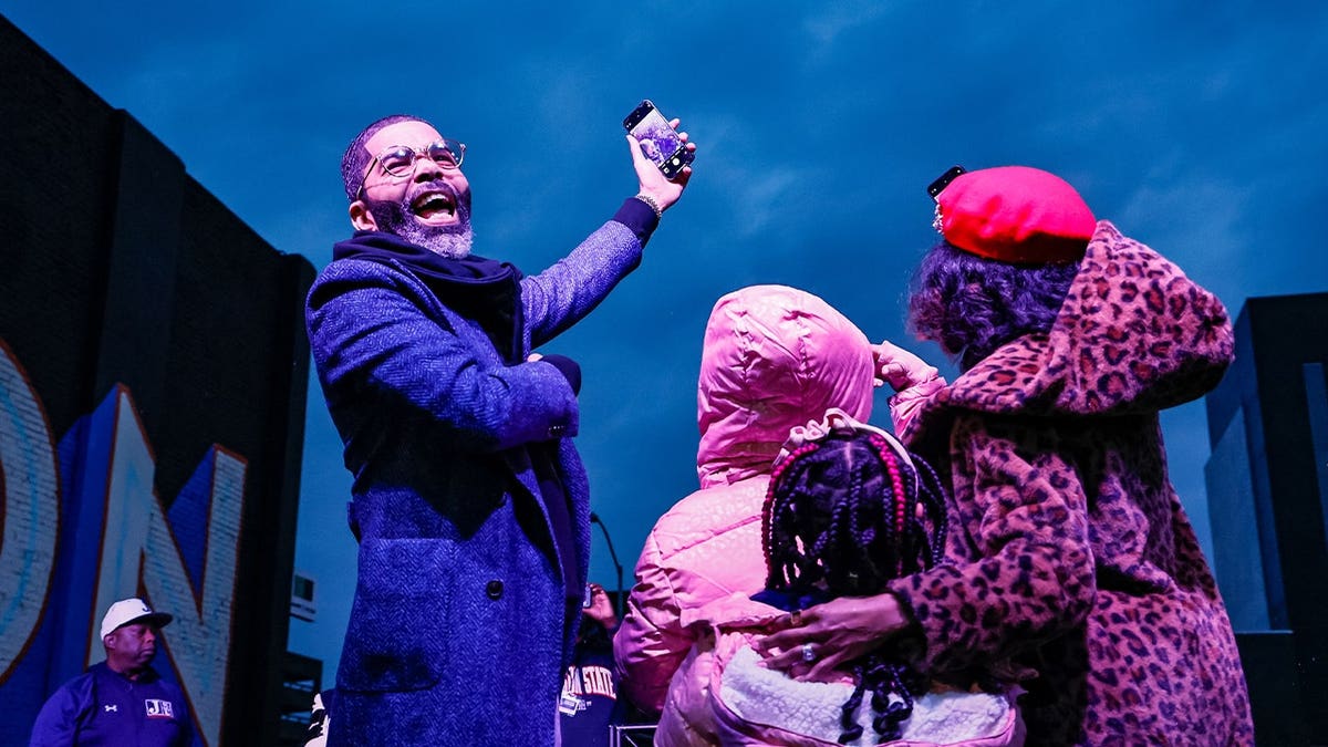 Then-City of Jackson Mayor Chokwe Antar Lumumba and his family take a selfie with attendees during the Celebration Kickoff Pep Rally at the Jackson State University Football National Champions Parade in downtown Jackson, Mississippi, on January 17, 2025.
