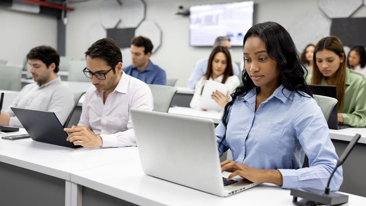 MBA students on laptops