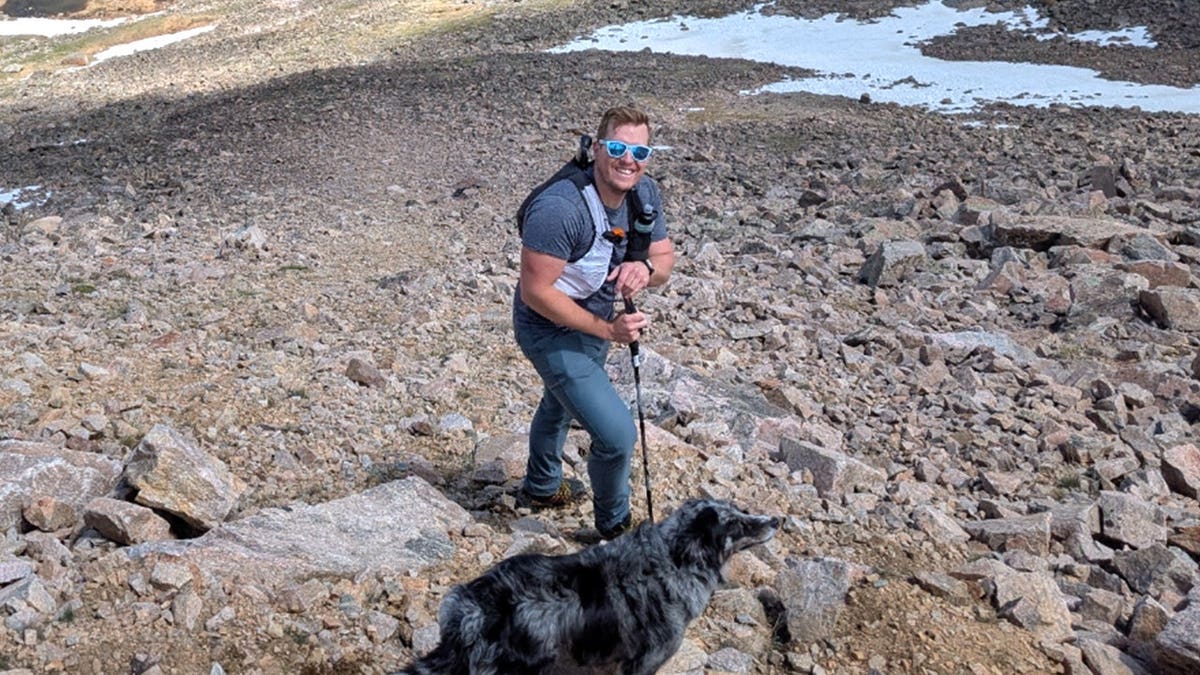 David Cifaldi smiling on hike with dog
