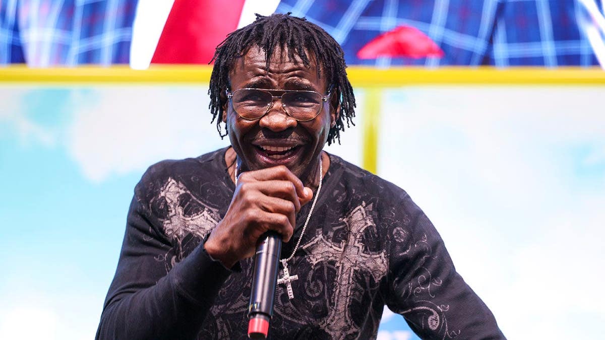 Michael Irvin talks to fans before the game in Miami.