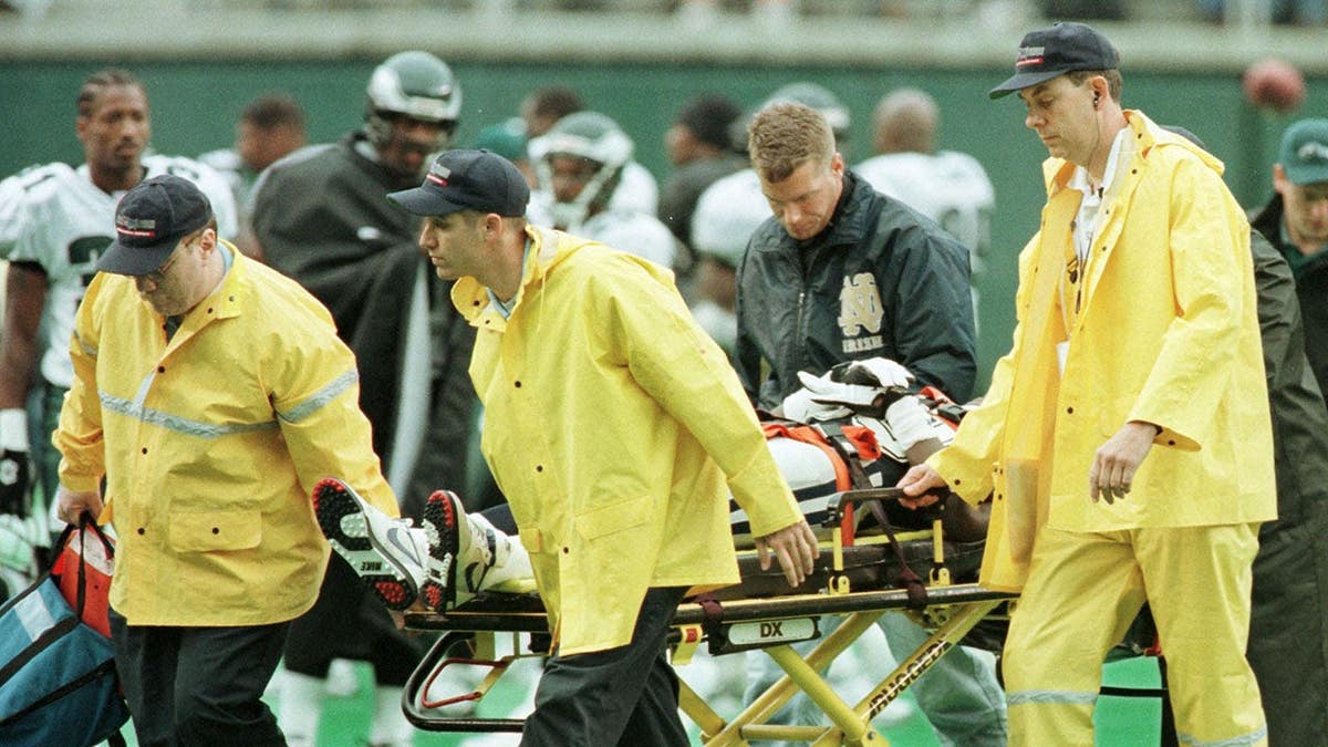 Michael Irvin is wheeled off the field toward an ambulance.