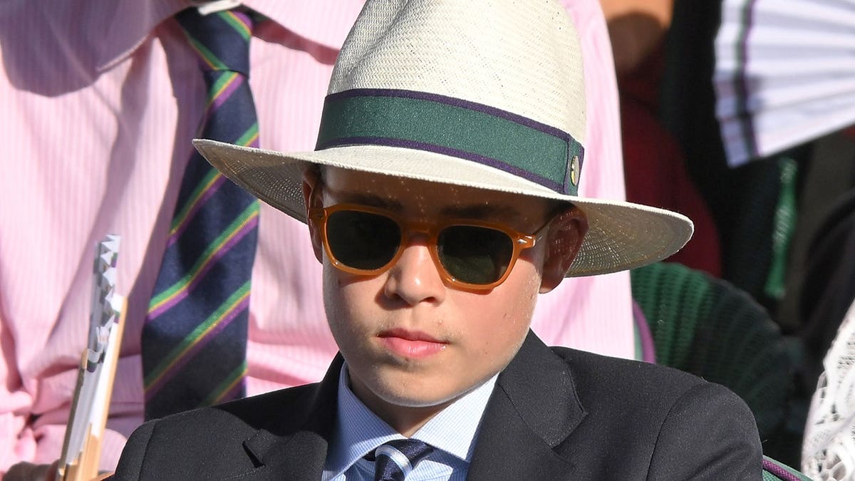 Prince George of Wales wears a hat and sunglasses at Wimbledon in London.