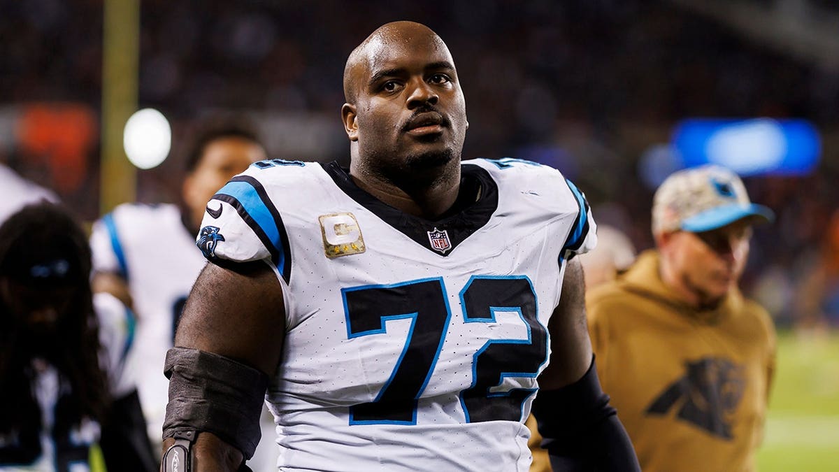 Taylor Moton stands on the sidelines during an NFL game