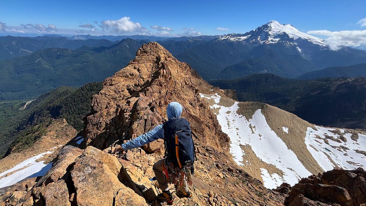 rescue team member looking out over mountain peak