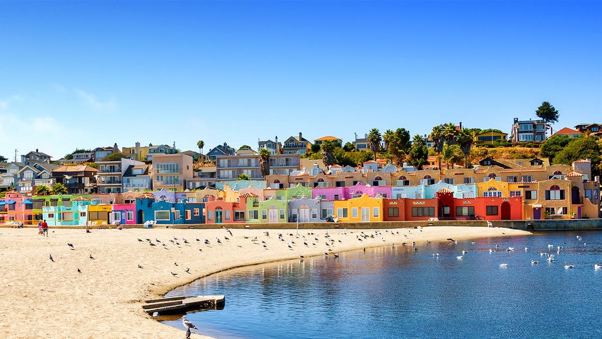 photo shows beach with colorful cottages