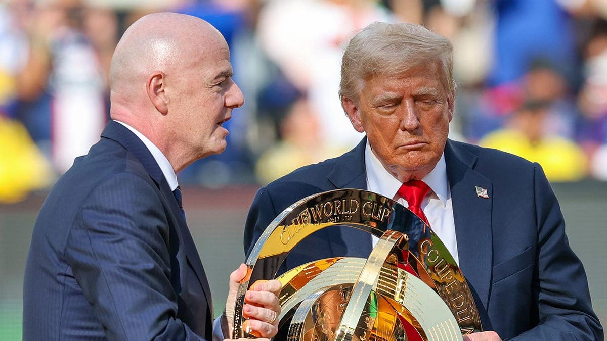 Gianni Infantino and Donald Trump present the trophy at MetLife Stadium.