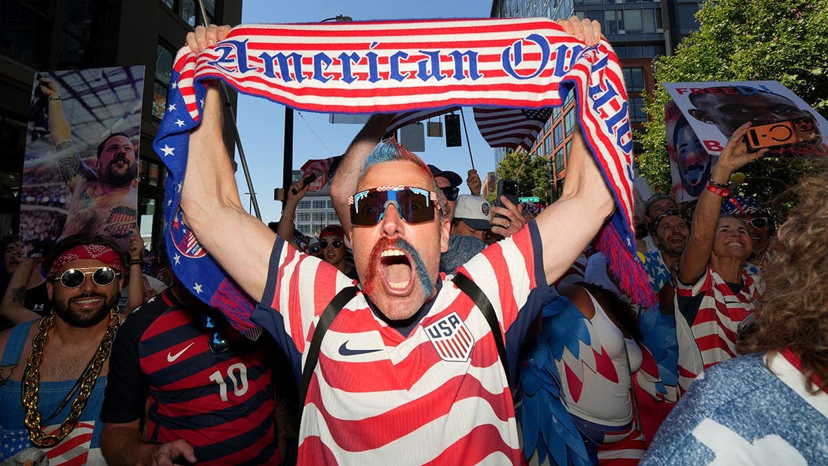 United States fans react during the march to the match before the World Cup round of 16 game vs. Belgium in Seattle.