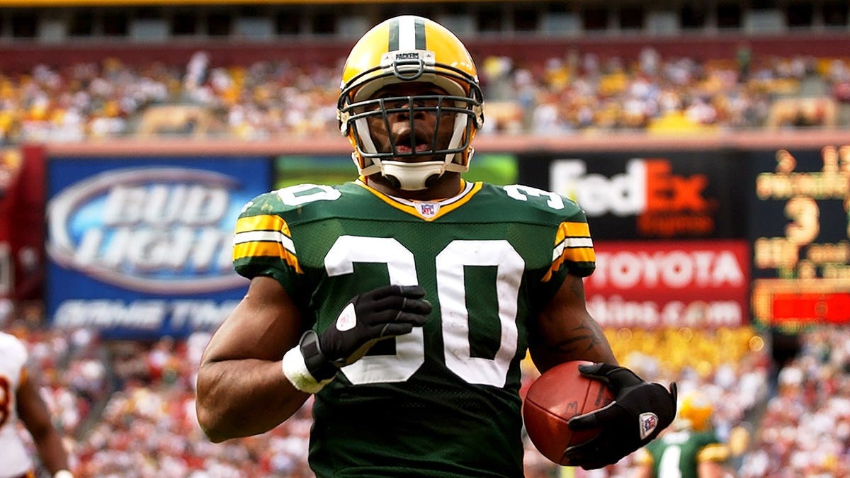 Ahman Green runs with the ball during an NFL football game.