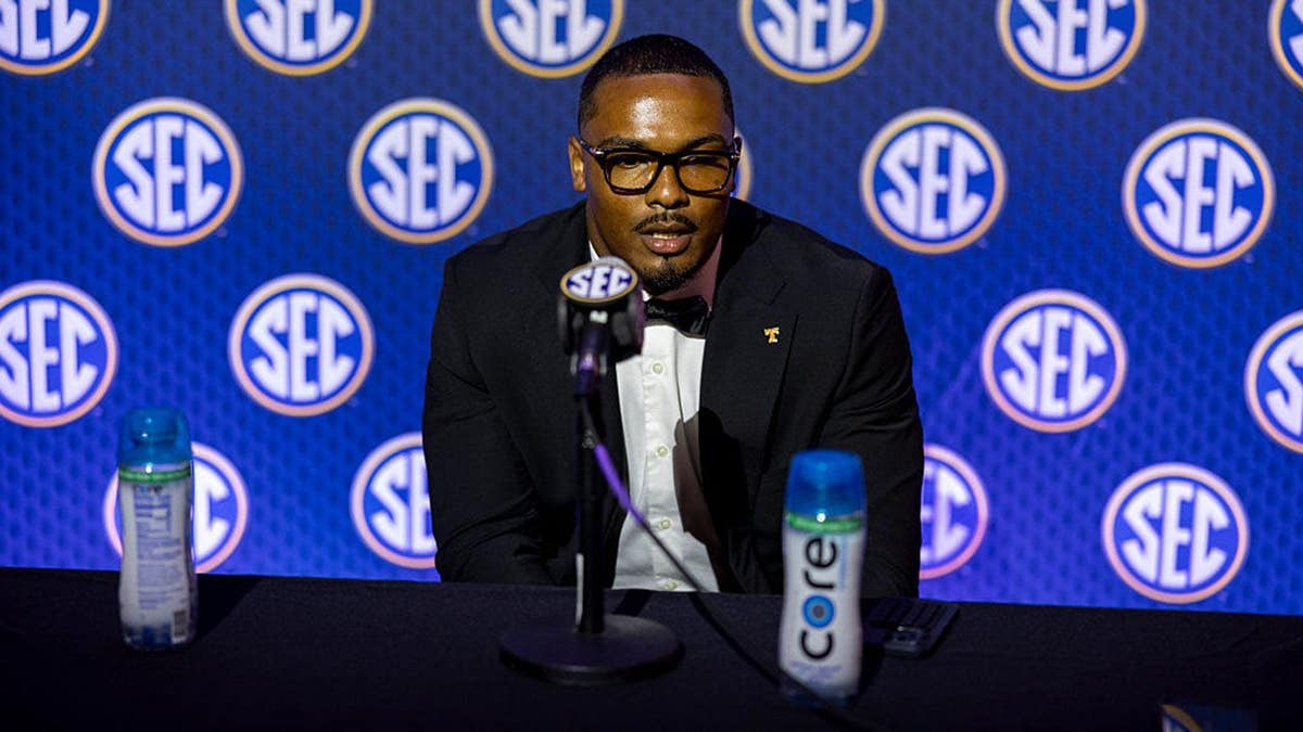 Arion Carter speaks at a podium during SEC Football Media Day.
