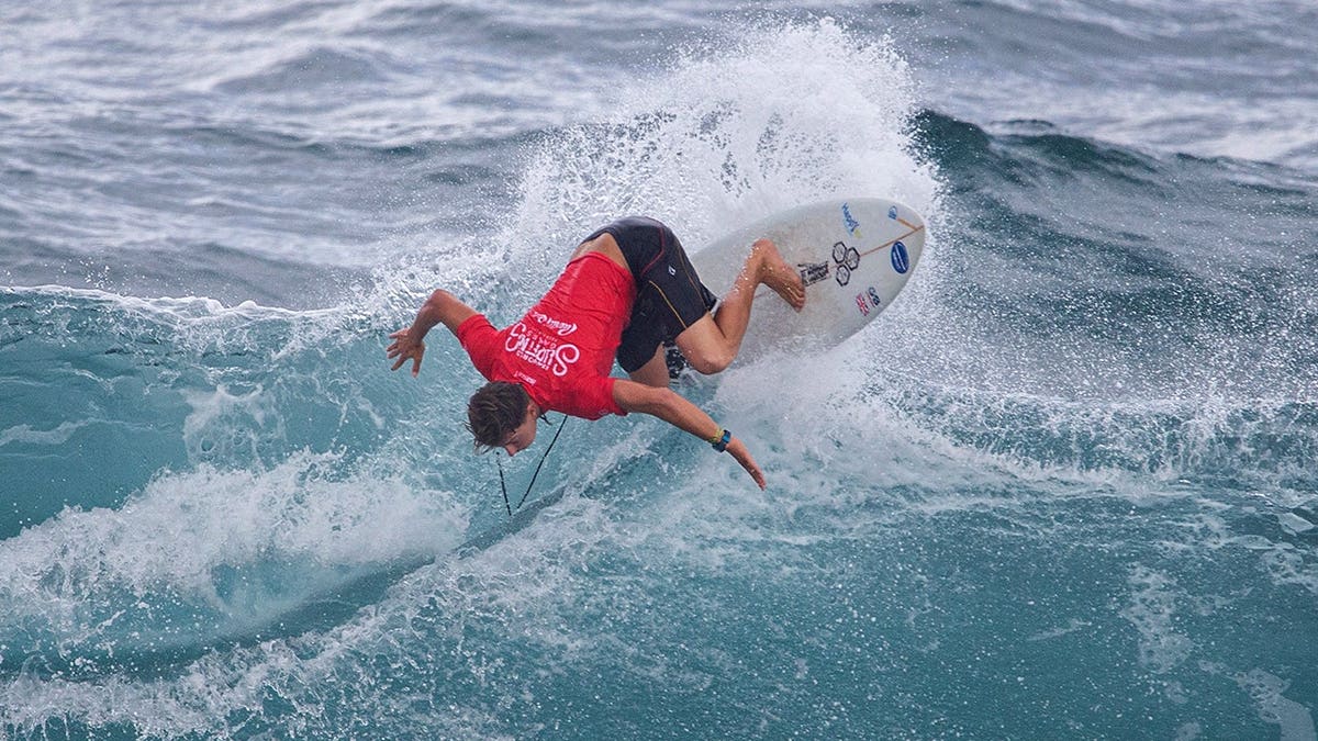 Arran Strong competes in surfing waves during the ISA World Surfing Games off La Marginal beach.