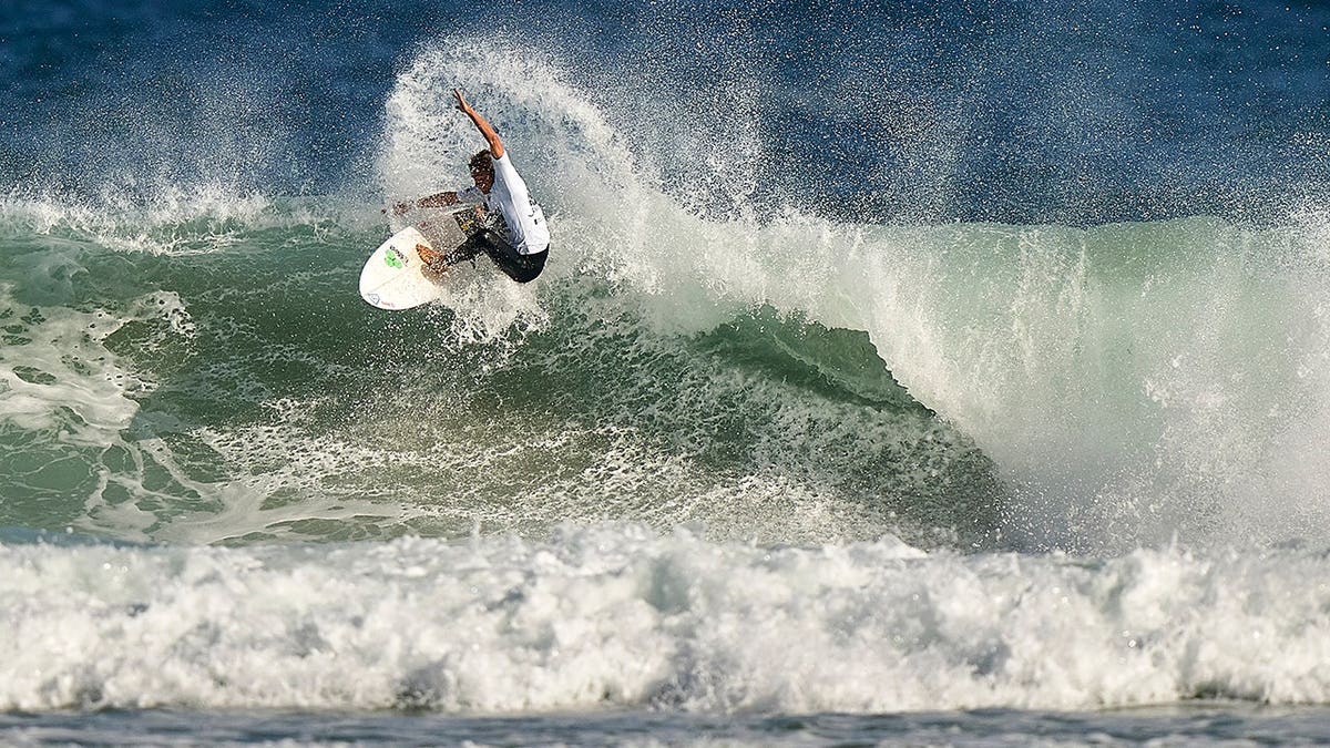 Arran Strong surfs in the ocean at Pantin Beach, La Coruna, Spain.