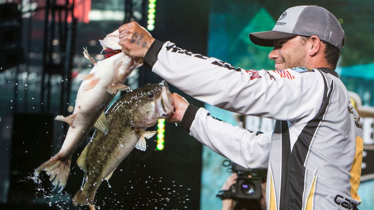 Jordan Lee holds up two fish at Minute Maid Park.