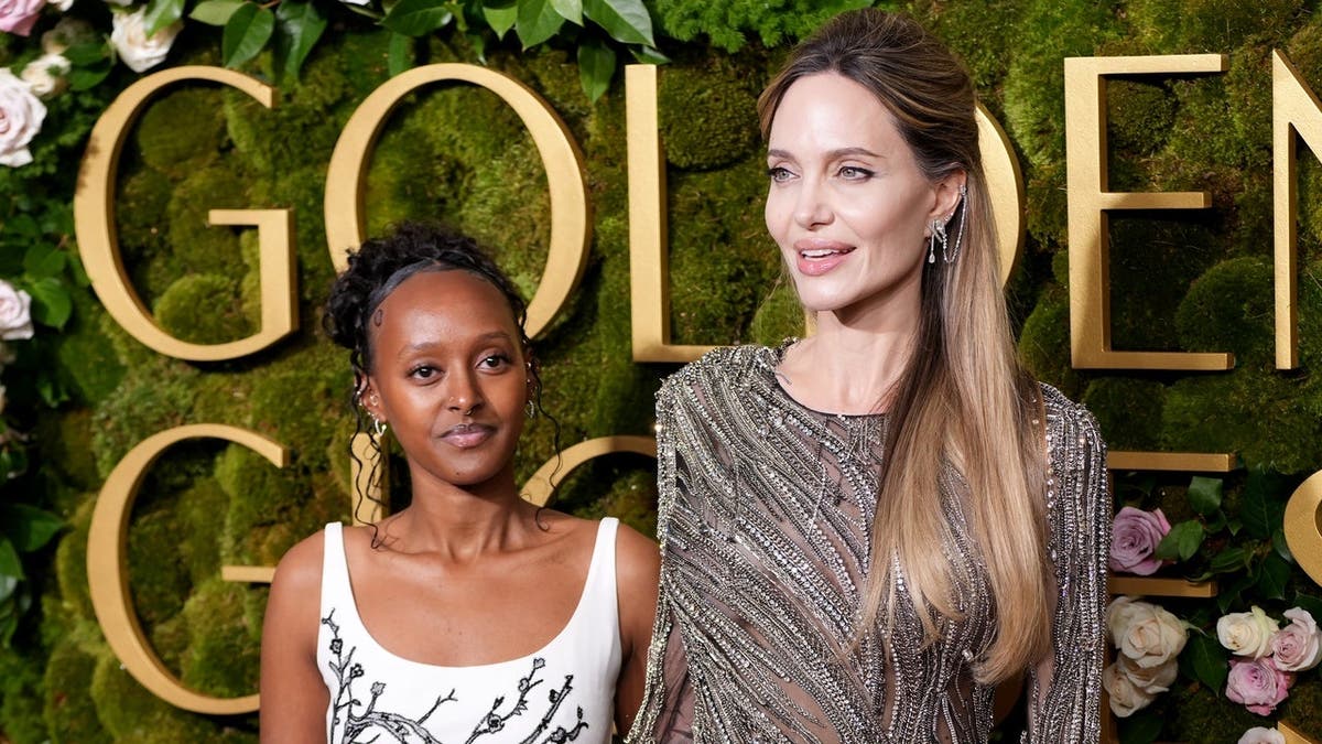 Zahara Jolie and Angelina Jolie pose at the Golden Globe Awards arrivals.