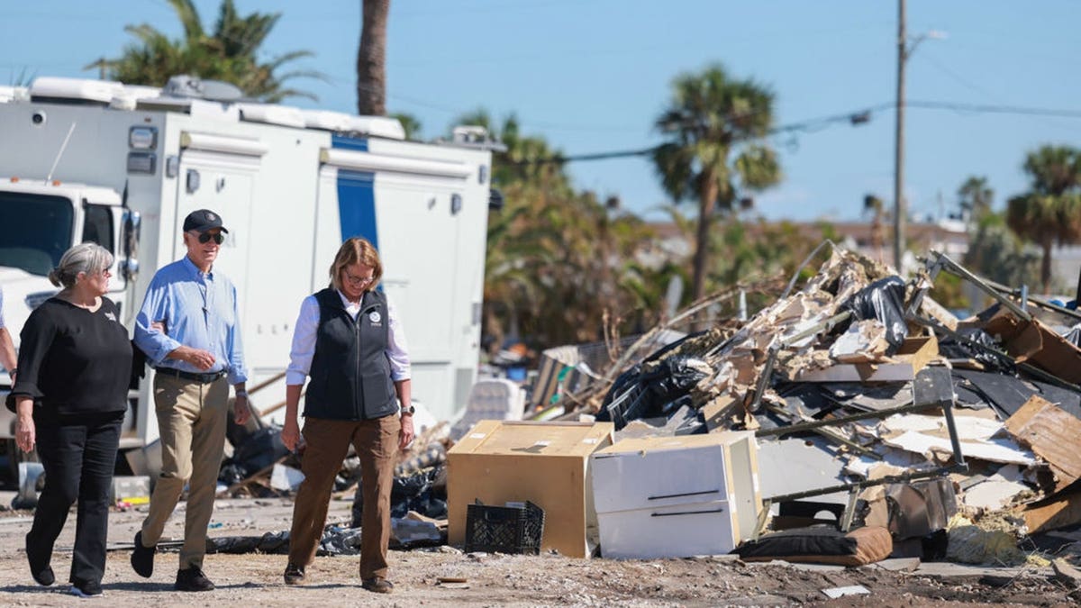 President Joe Biden walks with emergency officials during a Hurricane Milton damage tour in St. Pete Beach, Fla.