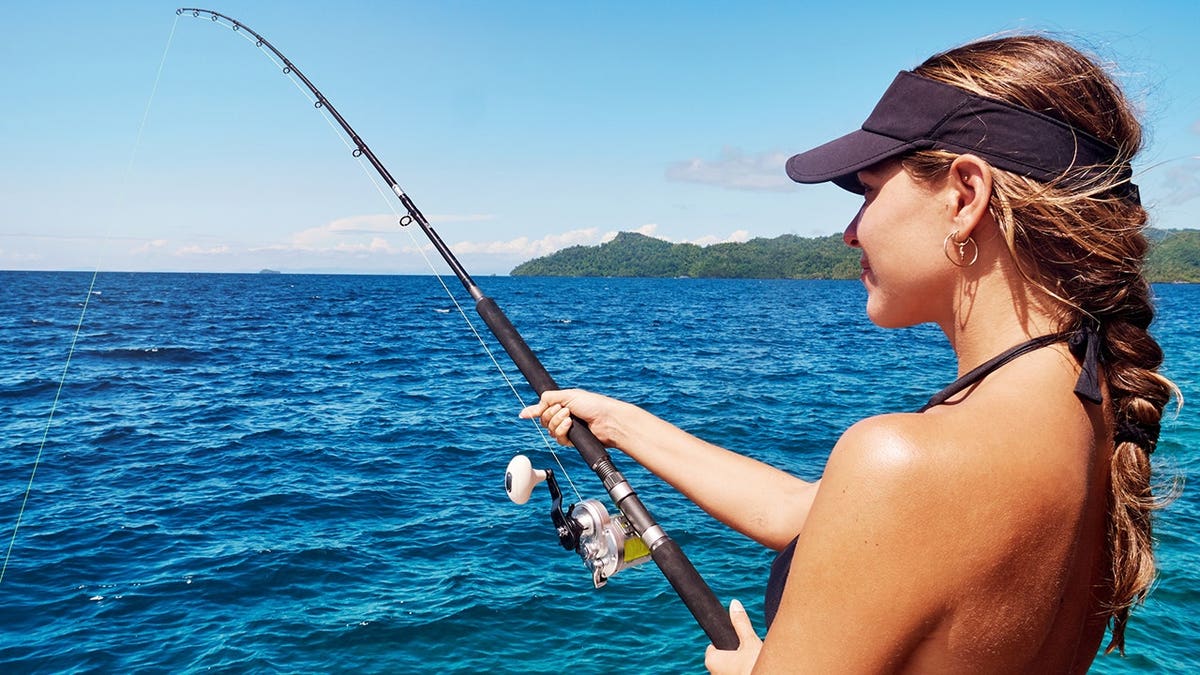 Young woman fishing on the sea