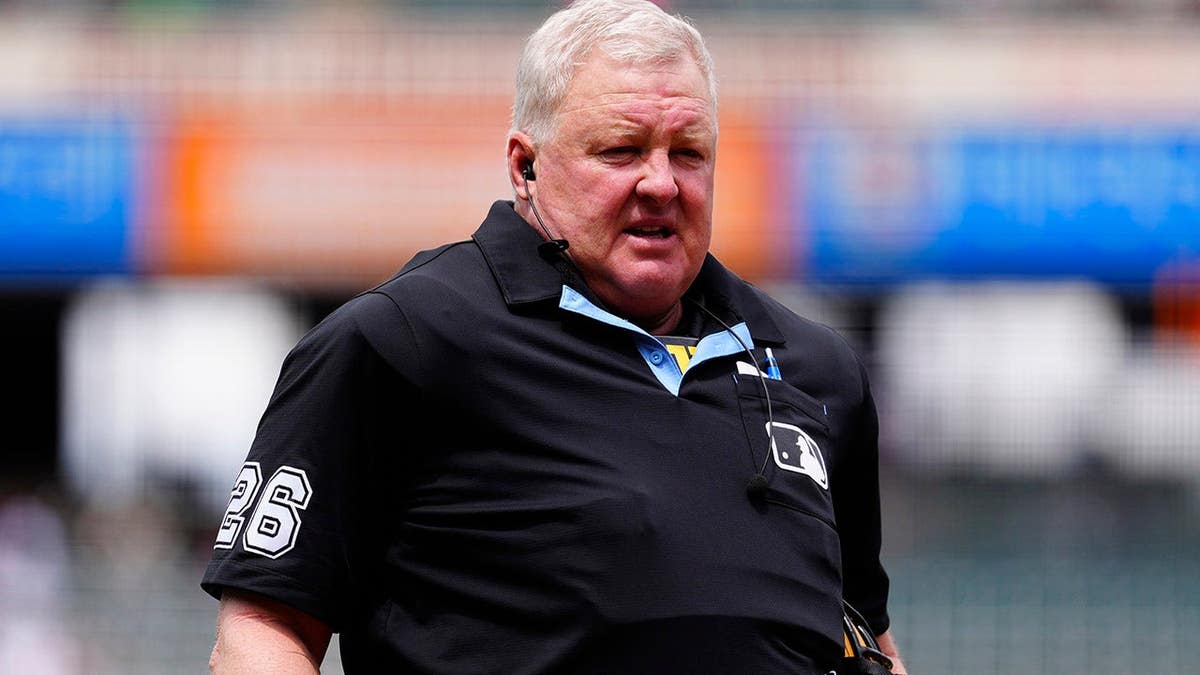 Bill Miller stands at home plate at Coors Field during a Braves-Rockies game.
