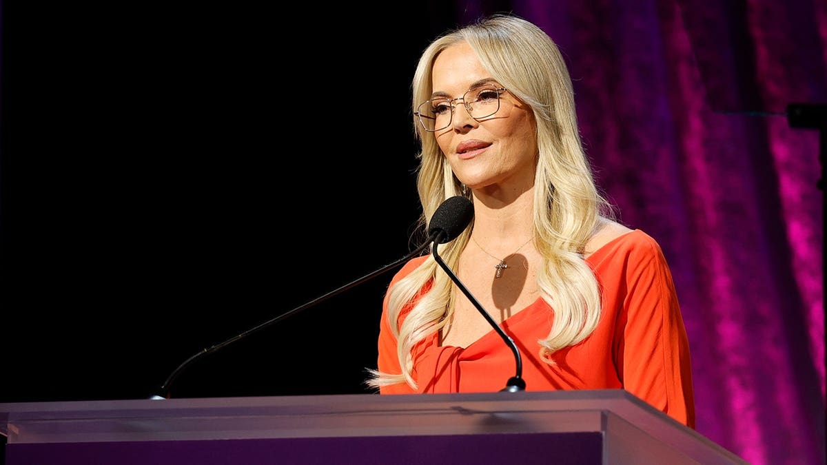 Brandy Ledford speaks onstage at an awards luncheon.