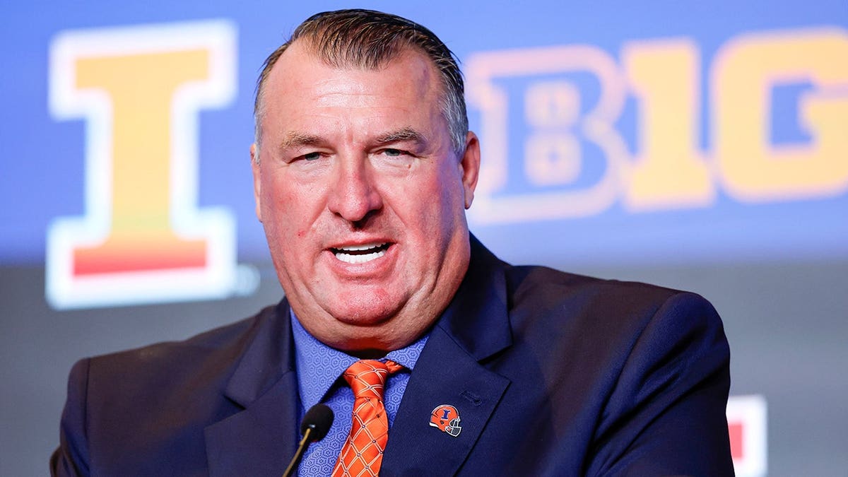 Bret Bielema speaks at a podium during Illinois football Media Days.