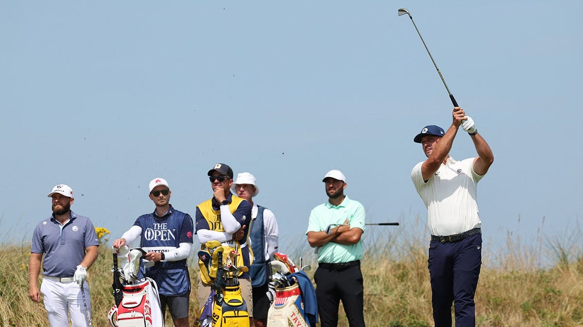 Bryson DeChambeau watches his changeable astatine nan 12th tee.