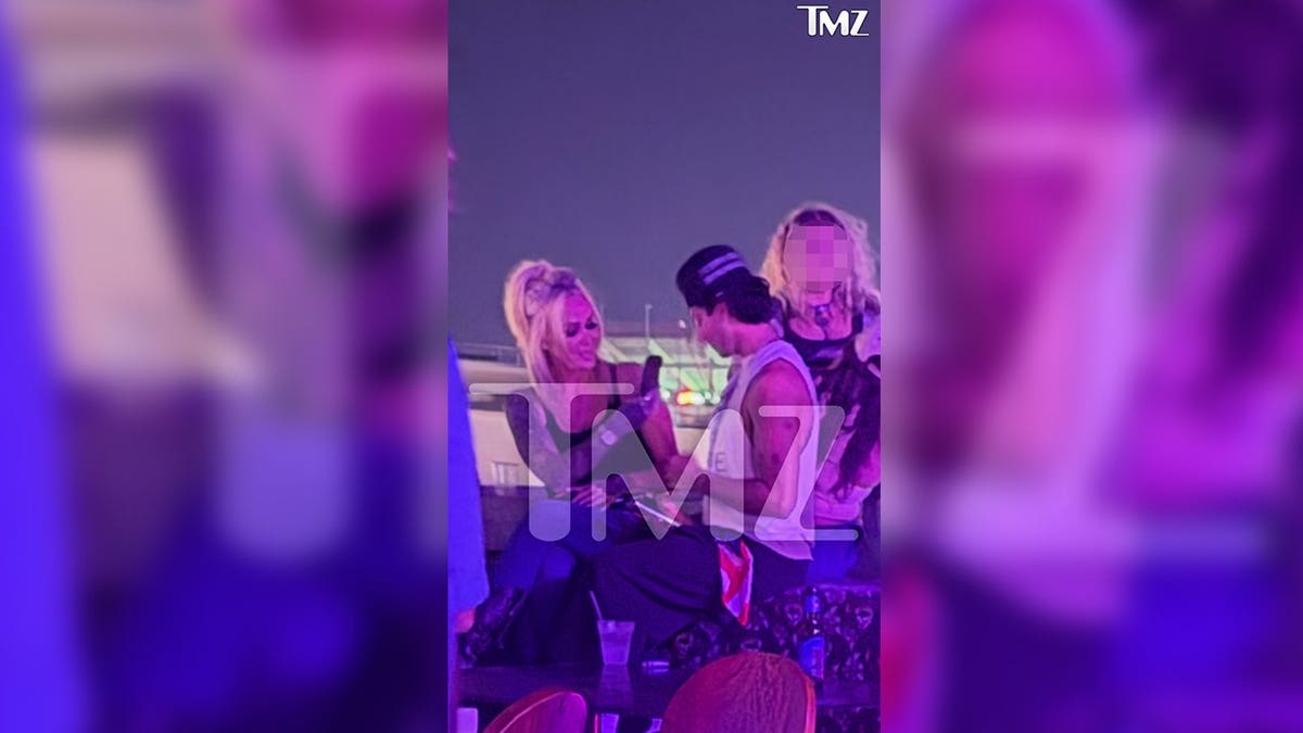 Bunnie XO and Dylan Wolf laugh at a bar