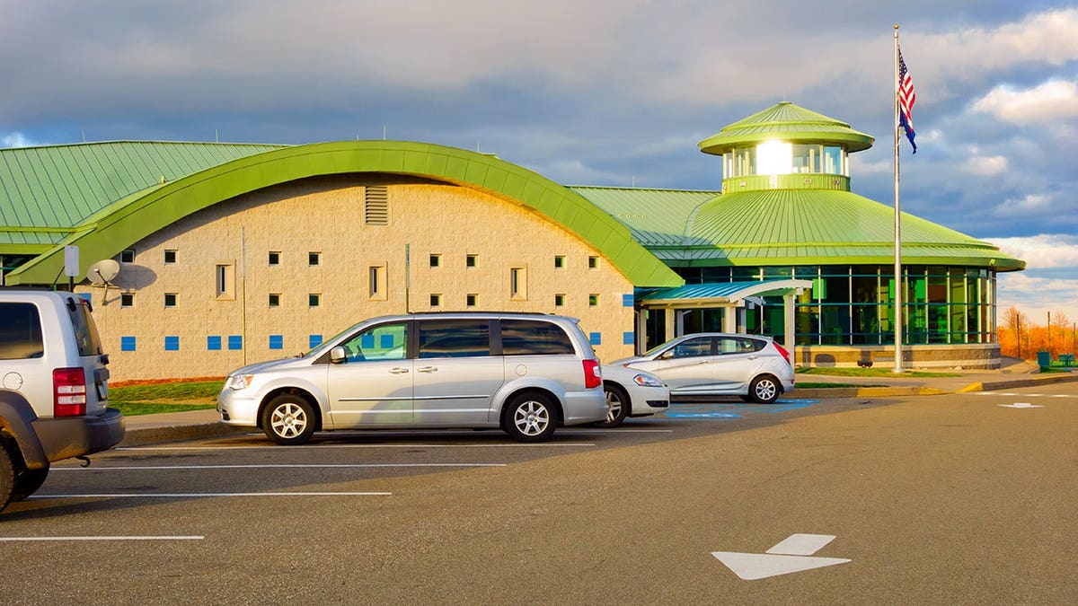 Cars parked at a rest stop.