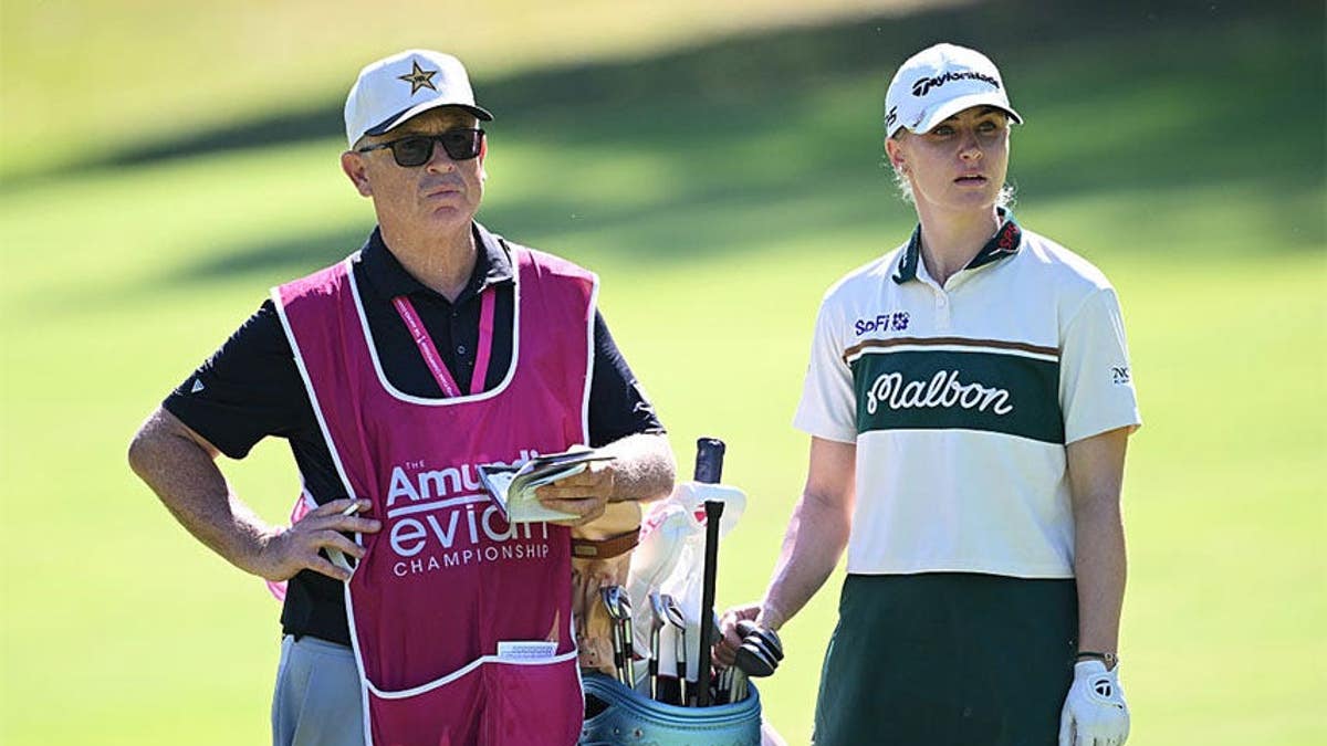 Charley Hull of England and her caddie, Adam Woodward