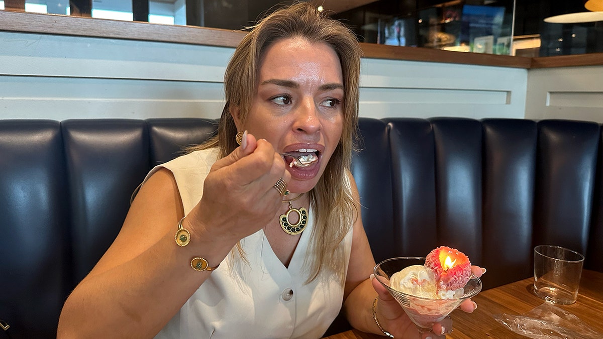 Claudia Mosley takes a bite of a raspberry edible candle.
