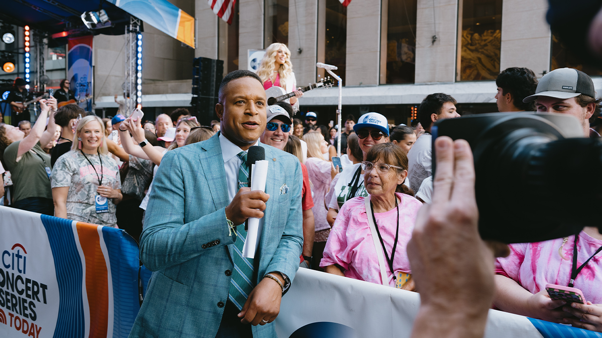 Craig Melvin successful a mint greenish suit speaking into a microphone extracurricular the Today workplace successful Manhattan