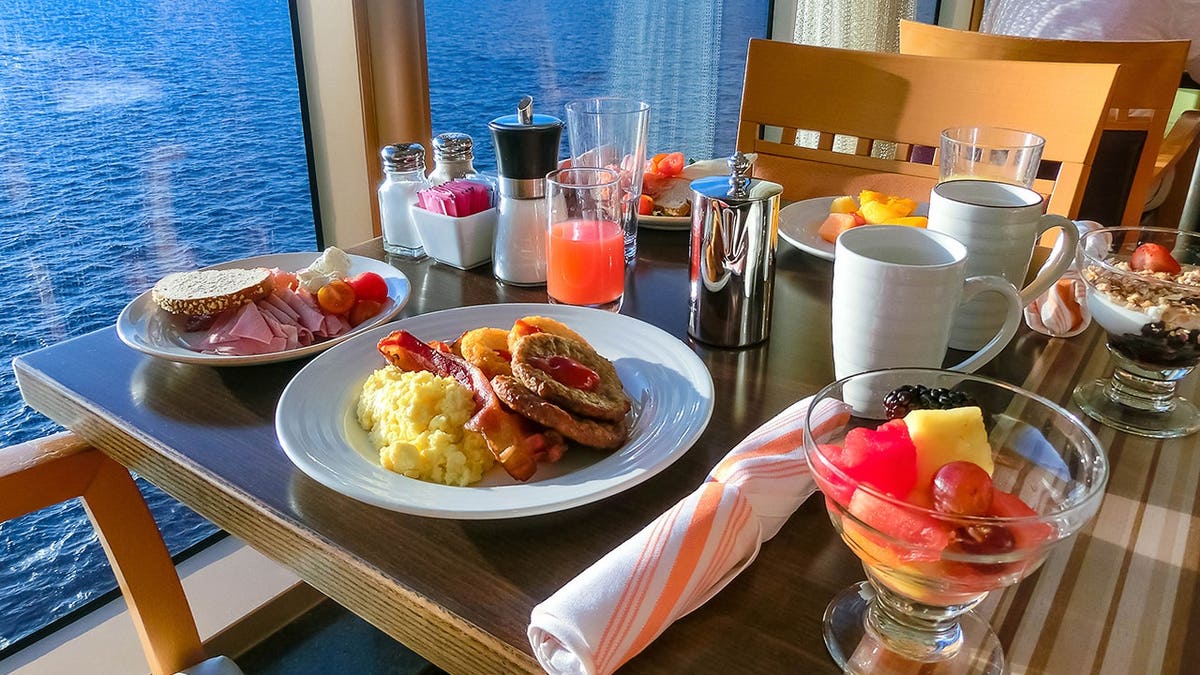 Buffet with burgers displayed in a cruise ship dining room.
