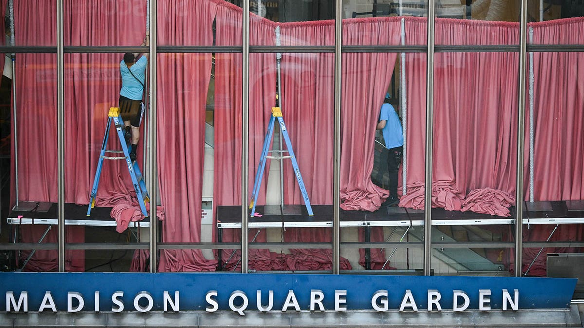 Red curtains are seen being put up inside Madison Square Garden