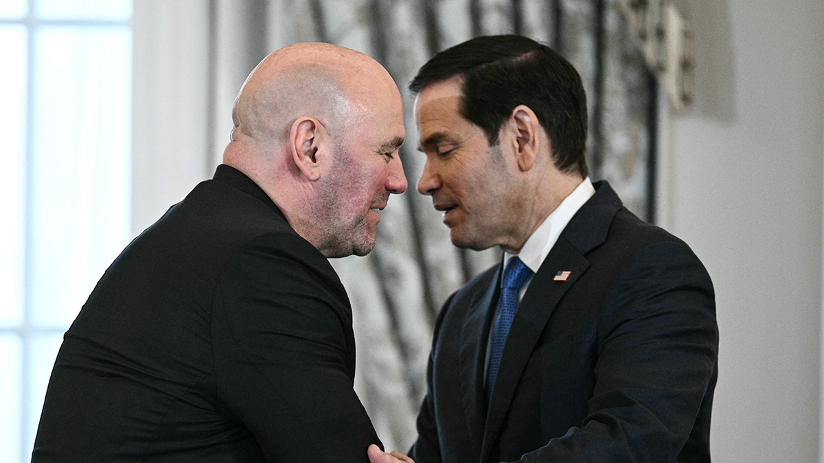 Dana White and Marco Rubio shake hands at a formal event.