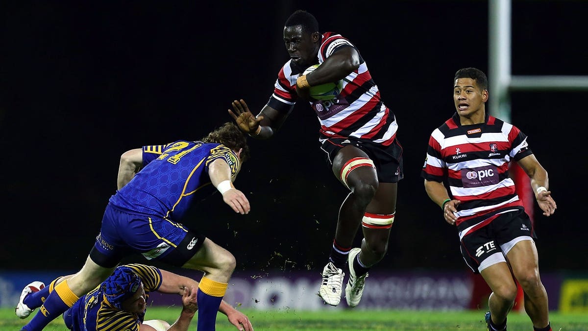 Daniel Adongo makes a break during a rugby match.