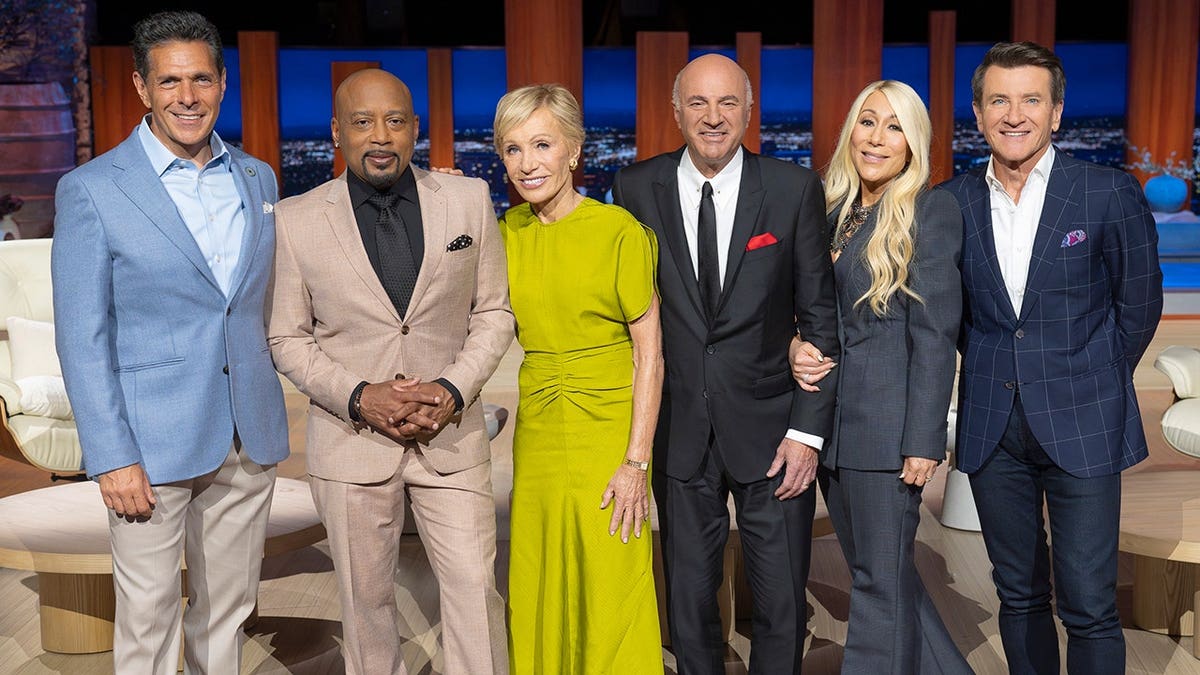 Daymond John poses with the other "Shark Tank" cast memebers