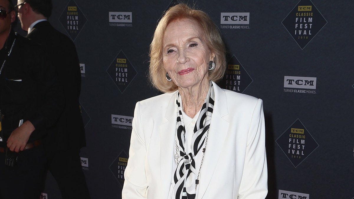Eva Marie Saint smiling and standing on a red carpet at the TCM Classic Film Festival.