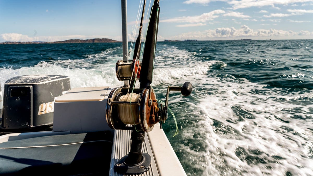 Fishing reels on a charter boat heading to a reef