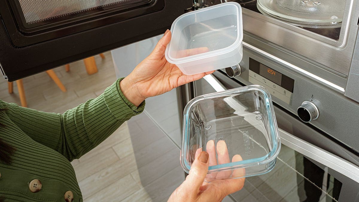 Plastic and solid containers positioned adjacent a microwave oven.